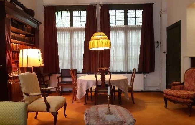 Voorkamer met tafel en boekenkast